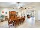 Dining room with large table, ceiling fan, arched doorways, and built-in hutch at 20630 N 42Nd Ave, Glendale, AZ 85308