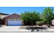 Charming home featuring a well-maintained front yard, mature trees, and an attached two-car garage at 20630 N 42Nd Ave, Glendale, AZ 85308