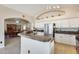 Open kitchen with stainless steel appliances, tile countertops, and a view into the dining room at 20630 N 42Nd Ave, Glendale, AZ 85308