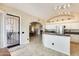 Bright kitchen with white cabinetry, stainless steel appliances, and an open layout leading to the dining area at 20630 N 42Nd Ave, Glendale, AZ 85308