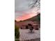 Captivating outdoor kitchen and patio with a vibrant sunset backdrop at 20630 N 42Nd Ave, Glendale, AZ 85308