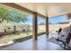 Relaxing covered patio with tile flooring, offering a comfortable outdoor living space with backyard views at 20630 N 42Nd Ave, Glendale, AZ 85308