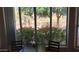 A peaceful table looking out to a window framing the outdoor landscape and flowering bushes at 20630 N 42Nd Ave, Glendale, AZ 85308