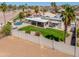 Backyard with lush lawn, pool, and covered patio, perfect for outdoor living and relaxation at 2077 N Lake Shore Dr, Casa Grande, AZ 85122
