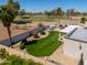 Private backyard featuring a well-maintained lawn, block fence, mature landscaping, and desert views at 2077 N Lake Shore Dr, Casa Grande, AZ 85122