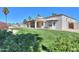 Expansive backyard featuring mature landscaping, a manicured lawn, and a covered patio at 2077 N Lake Shore Dr, Casa Grande, AZ 85122