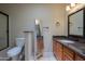 Cozy bathroom features a vanity, toilet, decorative mirror and enclosed shower at 2077 N Lake Shore Dr, Casa Grande, AZ 85122