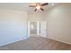 Bedroom showing neutral paint and carpet, ceiling fan and open doorway to hallway at 2077 N Lake Shore Dr, Casa Grande, AZ 85122