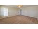 Bright bedroom features a ceiling fan, plush carpet and access to outdoor space at 2077 N Lake Shore Dr, Casa Grande, AZ 85122