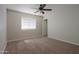 Bedroom displaying neutral carpet, a fan, and a window overlooking the community at 2077 N Lake Shore Dr, Casa Grande, AZ 85122