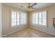 Bright dining area with tiled flooring, white shuttered windows, and a decorative ceiling fan at 2077 N Lake Shore Dr, Casa Grande, AZ 85122