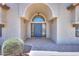 Inviting arched front entrance with stylish door and decorative sidelights at 2077 N Lake Shore Dr, Casa Grande, AZ 85122