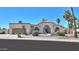 Charming home with desert landscaping, arched windows, and a neutral color palette at 2077 N Lake Shore Dr, Casa Grande, AZ 85122