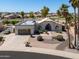 Inviting single-story home featuring a lush, landscaped yard and a convenient two-car garage at 2077 N Lake Shore Dr, Casa Grande, AZ 85122