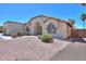 Exterior view of the house featuring gravel landscaping and neutral paint at 2077 N Lake Shore Dr, Casa Grande, AZ 85122