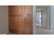 Hallway showing built-in wood cabinets and a view of an arched hallway to the front door at 2077 N Lake Shore Dr, Casa Grande, AZ 85122