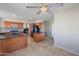 Spacious kitchen featuring stainless steel appliances, wood cabinets, a ceiling fan, and tiled flooring at 2077 N Lake Shore Dr, Casa Grande, AZ 85122