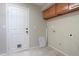Laundry room including tile floors, a door to exterior, and overhead storage cabinets at 2077 N Lake Shore Dr, Casa Grande, AZ 85122
