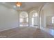 Open living room with arched doorways, carpet, and view of the front entrance at 2077 N Lake Shore Dr, Casa Grande, AZ 85122