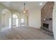 Bright living room with stone fireplace and an open floor plan at 2077 N Lake Shore Dr, Casa Grande, AZ 85122
