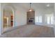Open concept living room with a stone fireplace and abundant natural light at 2077 N Lake Shore Dr, Casa Grande, AZ 85122