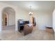 Office space with desk setup and a view of adjacent rooms through an arched opening at 2077 N Lake Shore Dr, Casa Grande, AZ 85122