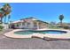 Backyard featuring a sparkling pool, mature palm trees, and patio area at 2077 N Lake Shore Dr, Casa Grande, AZ 85122