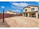 Gravel backyard featuring a brick border, covered patio, and privacy walls at 23359 W Cocopah St, Buckeye, AZ 85326