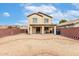 Gravel backyard featuring a brick border, covered patio, and privacy walls at 23359 W Cocopah St, Buckeye, AZ 85326