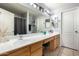 Bathroom featuring a double sink vanity with a large mirror and updated fixtures at 23359 W Cocopah St, Buckeye, AZ 85326