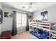 Bedroom with a bunk bed, window and ceiling fan at 23359 W Cocopah St, Buckeye, AZ 85326