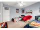 bedroom featuring a red papasan chair, ceiling fan and themed decorations on the walls at 23359 W Cocopah St, Buckeye, AZ 85326