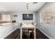 Bright dining area with modern table and chairs, an adjacent breakfast bar and dark wood floors at 23359 W Cocopah St, Buckeye, AZ 85326