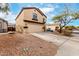 Two-story home featuring a two-car garage, neutral paint and desert landscaping at 23359 W Cocopah St, Buckeye, AZ 85326
