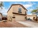 Two-story home featuring a two-car garage, neutral paint and desert landscaping at 23359 W Cocopah St, Buckeye, AZ 85326
