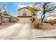 Two-story home featuring a two-car garage, neutral paint and desert landscaping at 23359 W Cocopah St, Buckeye, AZ 85326