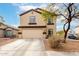 Two-story home featuring a two-car garage, neutral paint and desert landscaping at 23359 W Cocopah St, Buckeye, AZ 85326