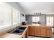 Bright kitchen area featuring a sink beneath a window and a view of the adjacent dining space at 23359 W Cocopah St, Buckeye, AZ 85326