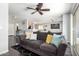 Cozy living room featuring hardwood floors, a gray sofa, and an open floor plan at 23359 W Cocopah St, Buckeye, AZ 85326
