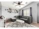 Cozy living room featuring vaulted ceilings, a ceiling fan, and a comfortable gray sectional sofa at 23359 W Cocopah St, Buckeye, AZ 85326