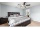 Bedroom with a dark wood frame bed and side table with an ensuite bathroom at 23359 W Cocopah St, Buckeye, AZ 85326