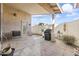 Covered patio with gray concrete flooring, garbage cans and partial view of the yard at 2348 W Laurel Ln, Phoenix, AZ 85029