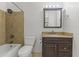 Bathroom features a shower over tub combination with tiled walls and a dark wood vanity with a granite countertop at 2348 W Laurel Ln, Phoenix, AZ 85029