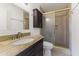 This bathroom boasts a granite counter top, dark wood vanity, and an enclosed shower with a glass door at 2348 W Laurel Ln, Phoenix, AZ 85029
