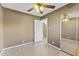 Bedroom featuring ceiling fan, tile floors and mirror closet doors at 2348 W Laurel Ln, Phoenix, AZ 85029