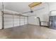 Garage showing large white garage door, utility sink and concrete flooring at 2348 W Laurel Ln, Phoenix, AZ 85029