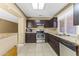 Modern kitchen features granite countertops, stainless steel appliances, and tile floors at 2348 W Laurel Ln, Phoenix, AZ 85029