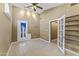 Open living room with tile floors, ceiling fan and white french doors to backyard at 2348 W Laurel Ln, Phoenix, AZ 85029