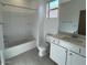 Modern bathroom featuring white cabinets, a bathtub, and tile floors at 25156 W Wayland Dr, Buckeye, AZ 85326