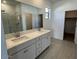 Bathroom featuring a double vanity, walk-in shower, and tile floors at 25156 W Wayland Dr, Buckeye, AZ 85326